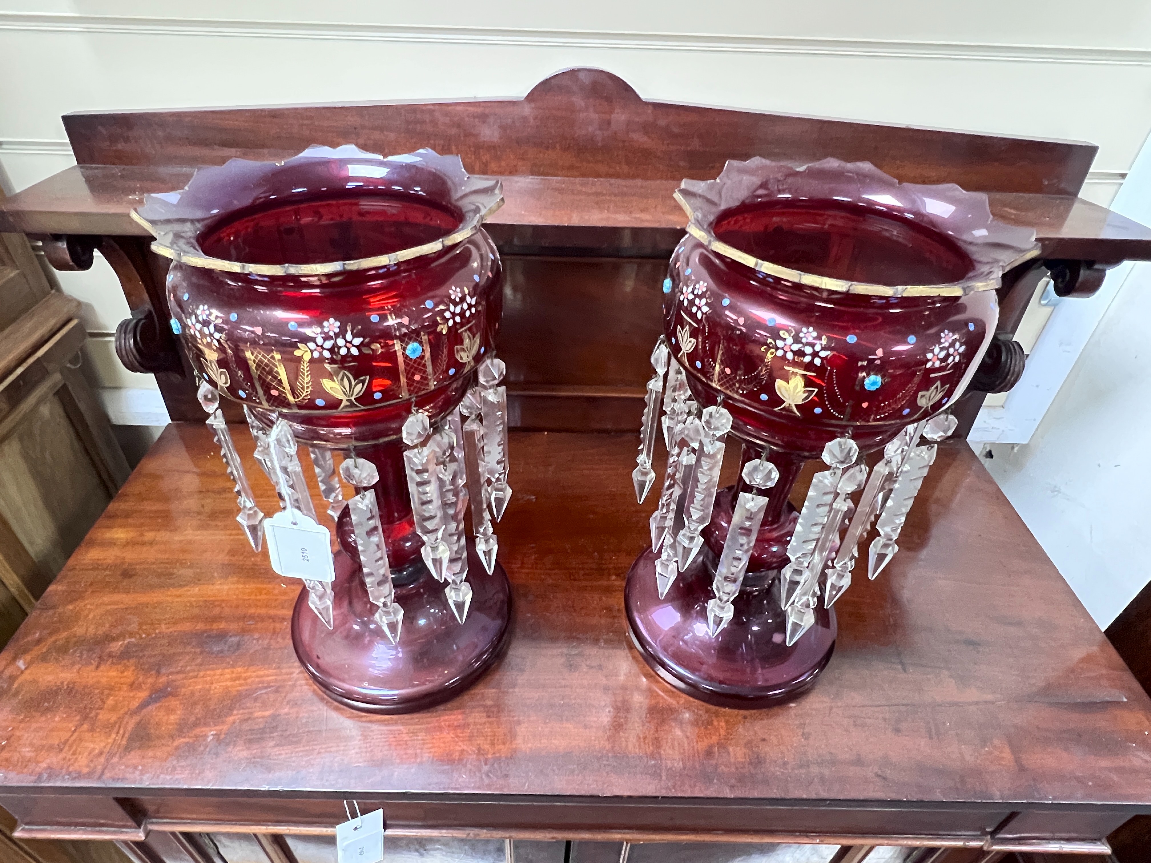 A pair of Victorian ruby glass table lustres, 36 cms high